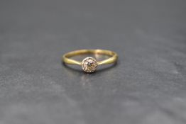 An 18ct gold diamond set solitaire ring, the illusion set brilliant cut diamond measuring