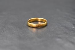 A 22ct gold band, of plain rounded form, marked 22 with hallmarks, ring size N-O, 4g