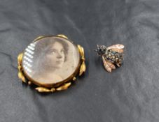 A yellow metal sapphire and seed pearl set insect brooch, the bee motif having round cut sapphires