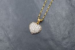 An 18ct gold diamond encrusted heart pendant having thirty five small pave set diamonds totalling