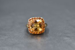 A 9ct gold citrine cluster ring by QVC having a square cushion cut citrine within a halo of small