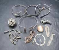 An assortment of silver and white metal jewellery, including snake motif bracelets, neck chains