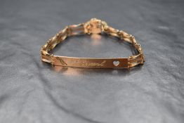 A 9ct gold identity bracelet, the rectangular panel having a heart cut out engraved 'Hazel' on a