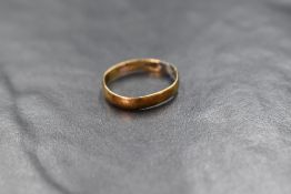 A broken yellow metal wedding with worn marks, tests as 18ct gold, approx 2g