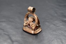 A yellow metal fob having a monogrammed cornelian intaglio bearing initials E S. no marks tests as