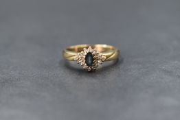 A 9ct gold possibly tanzanite and diamond chip cluster ring of dainty form, on broad shoulders and