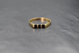 An 18ct gold onyx set ring, the three onyx panels interspersed with gold bars, marked 750, ring size