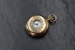 A small 12.5ct rose gold half hunter top wound pocket watch having an Arabic numeral dial with