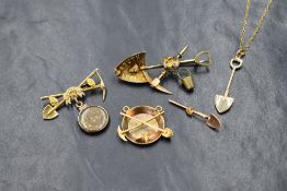 A 10ct gold Alaska gold mining motif brooch, having crossed pick and shovel with gold nuggets and