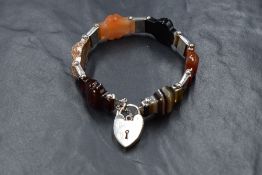 A Victorian Scottish hard stone bracelet, set with five carved panels of assorted hard stones with