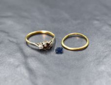 A yellow metal presumed gold sapphire and diamond set three stone ring, the central emerald cut