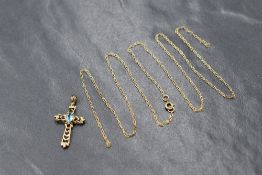 A yellow metal open cross pendant having a central blue topaz stone, marks worn but presumed 9ct