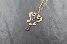 A 9ct gold Edwardian style pendant having seed pearl and amethyst decoration on a 9ct gold flat curb