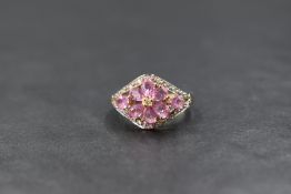 A 9ct gold pink sapphire cluster ring by QVC, having a central daisy cluster within a border