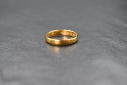A 22ct gold band, of plain rounded form, ring size J, 2.4g