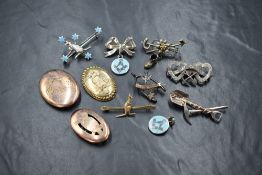 An assortment of silver brooches, including three gold plated silver depicting kookaburras, mining