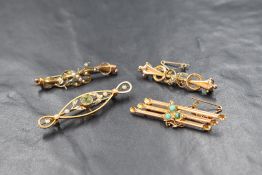 A group of three 9ct gold bar brooches, comprising two seed pearl set scroll motif brooches, a