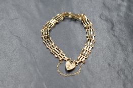 A 9ct gold four bar gate bracelet with padlock clasp, safety chain broken, approx 4.5g