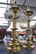 A set of two late 20th-century polished brass Stiffel-style table lamps, featuring tiered