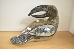 A large 20th century Mexican folk art pottery toucan, decorated with floral and repeating designs,