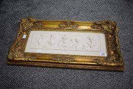 A reproduction Parian ware style plaque, of rectangular form and decorated in relief with putto