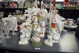 A collection of Victorian Staffordshire pottery, to include flatback figures, spill vases,