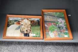 Two modern framed art prints, comprising: a cow, 33.5 × 23.5 cm, and a floral scene, 33.5 × 25 cm (