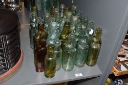 A collection of 25 20th-century Codd-neck glass bottles, featuring examples marked ‘J. Baxendale,
