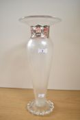 An attractive art glass vase, having a flared rim over a silvered moulded neck and a fluted tapering