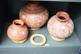 A group of three Mexican Mata Ortiz type pottery vessels, with incised decoration and rounded bases,