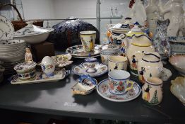 A selection of 20th-century modern Henriot Quimper French pottery, featuring a holy statue of