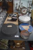 A collection of early 20th-century film reels, including a Kodak reel for a Kodascope, with