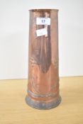 An Arts and Crafts hammered copper and decoratively embossed vase, of cylindrical form with stylised