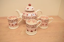 An Emma Bridgewater pottery Sampler pattern teapot with pink hearts and three matching mugs, printed