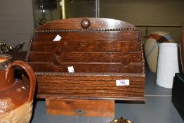 An early 20th-century crafted oak letter rack, featuring decorative bead-edge detailing, 34cm.