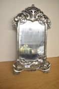 A late-20th century resin Art Noveau style silver effect easel mirror, having a decorative vine