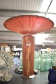 A modern decoartive glass table lamp, having a flared bowl over cylindrical base of gilt and red