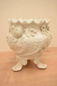 A large Belleek porcelain footed Jardiniere, of stylised shell form with serrated rim over a body