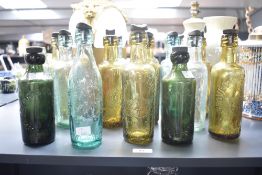 A mixed lot of nineteen 20th-century British glass bottles, including examples marked ‘Groves and
