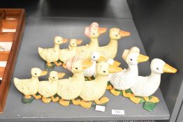 Three vintage cast iron Ducks in a row doorstops, featuring a family of colourfully painted