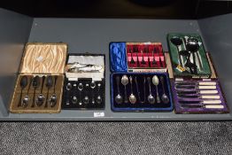 A selection of 20th-century silver-plated, white metal, and stainless steel cutlery sets,