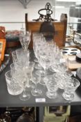 A collection of 24 crystal-cut and cut glassware pieces, including wine glasses, tumblers, and