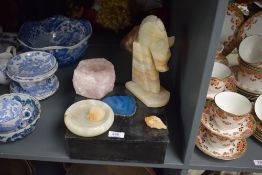 A pink quartz candle holder of naturalistic form with circular aperture, sold together with an