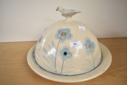 A large modern studio pottery cheese dish with domed cover, featuring a hand-painted snake, flowers,