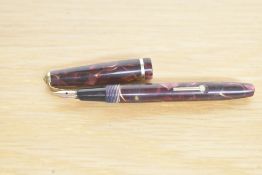 A Conway Stewart Dinkie 560 lever fill fountain pen in rose and black marble having Conway 14ct gold