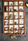 A collection of 23 late 20th-century to modern Arts and Crafts owl figurines, made from a variety of