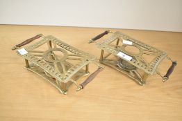 A pair of 20th century brass warming plates with turned wooden handles, both 22.5cm