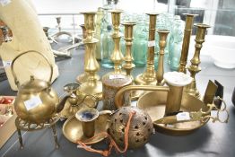 A collection of eight 20th-century brass candlesticks, including a pair of Georgian-style adjustable