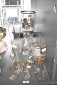 A collection of nine late 20th-century/modern German boot-shaped beer glasses, six featuring novelty