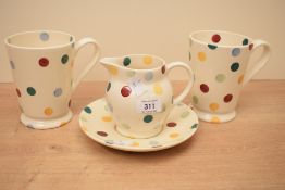 A group of four Emma Bridgewater pottery polka dot pattern wares, comprising two tall mugs and a